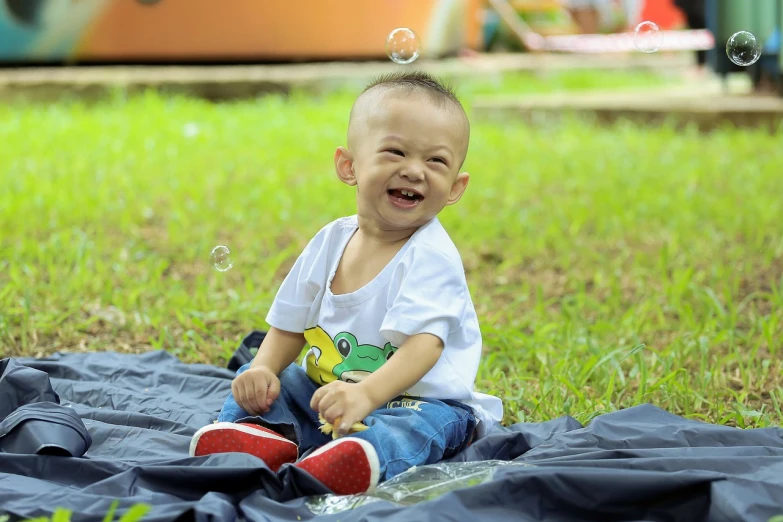 a little boy that is sitting on a blanket, a picture, by Basuki Abdullah, lots of bubbles, grinning lasciviously, 15081959 21121991 01012000 4k, sangyeob park