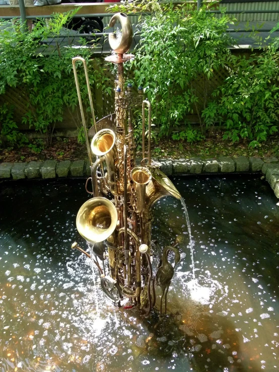 there is a fountain with musical instruments in it, by Viktor de Jeney, saxophones, ny, vine art, heaven on earth