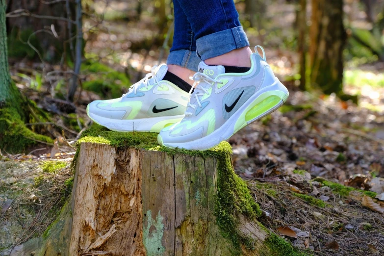 a person standing on top of a tree stump, a picture, by Niko Henrichon, nike air max, white neon, cottagecore!! fitness body, spring colors