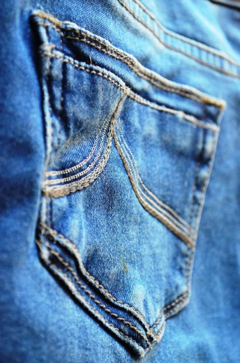 a close up of a pocket of a pair of jeans, a macro photograph, happening, taken with a pentax1000, high details photo, warm sunshine, blue clothes