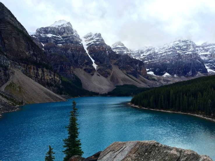 a large body of water surrounded by mountains, a photo, by Brigette Barrager, banff national park, usa-sep 20, cold blue colors, spectacular rocky mountains