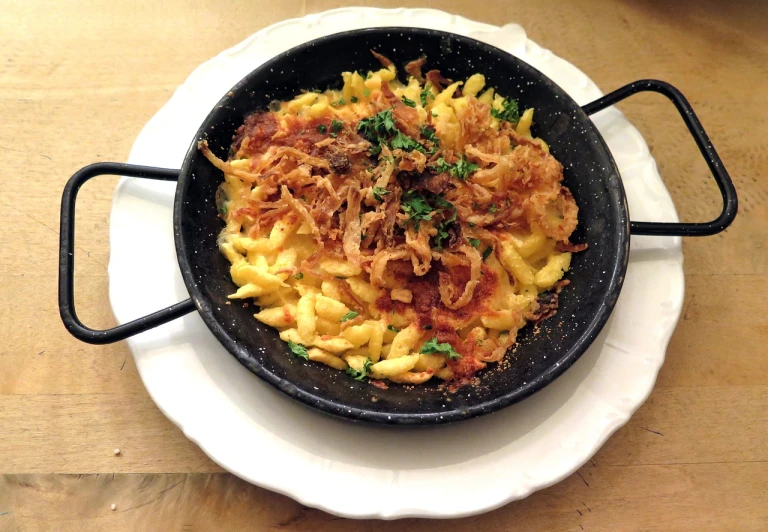 a white plate topped with macaroni and cheese, by Tom Wänerstrand, hurufiyya, red meat shreds, kreuzberg, 19 century, wok