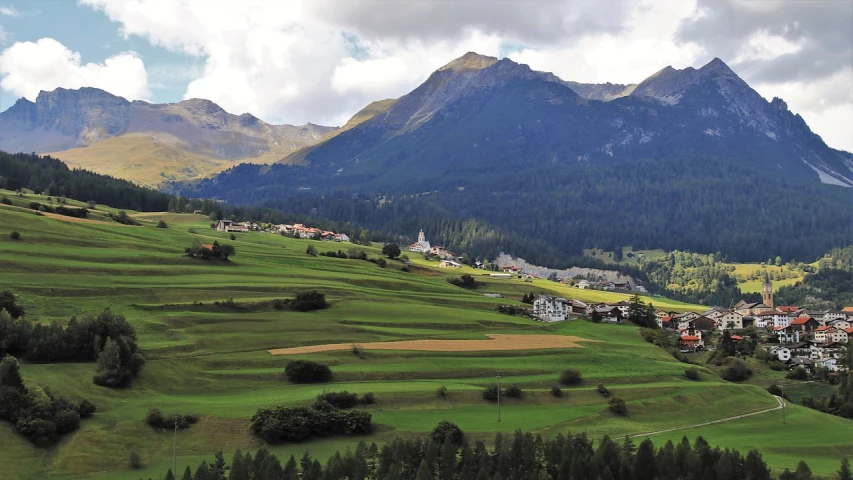 a view of a small town in the mountains, a photo, by Werner Andermatt, flickr, i see fields of green, orazio gentileschi style, gigantic landscape!, church