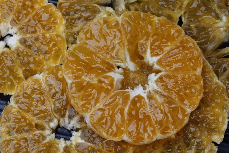 a close up of a bunch of orange slices, by Dietmar Damerau, process art, honeycomb, glazed, chinese, detailed veiny muscles