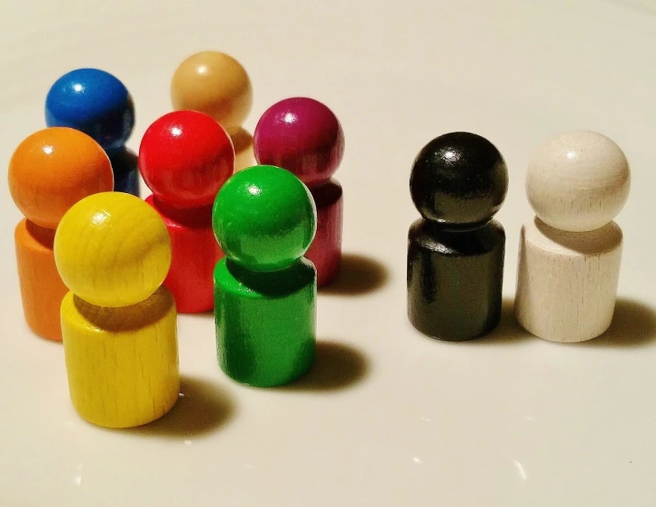 a group of wooden pegs sitting on top of a table, a picture, flickr, color field, stick figures, marbles, standout colours, r / paintedminis