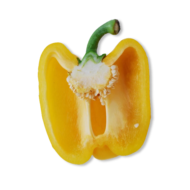 a yellow bell pepper cut in half on a black background, a macro photograph, various posed, miniature product photo