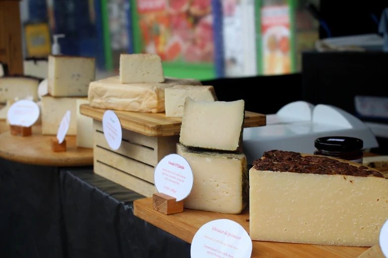 a table topped with lots of different types of cheese, private press, product display, on a sunny day, close up photo, in 2 0 1 8