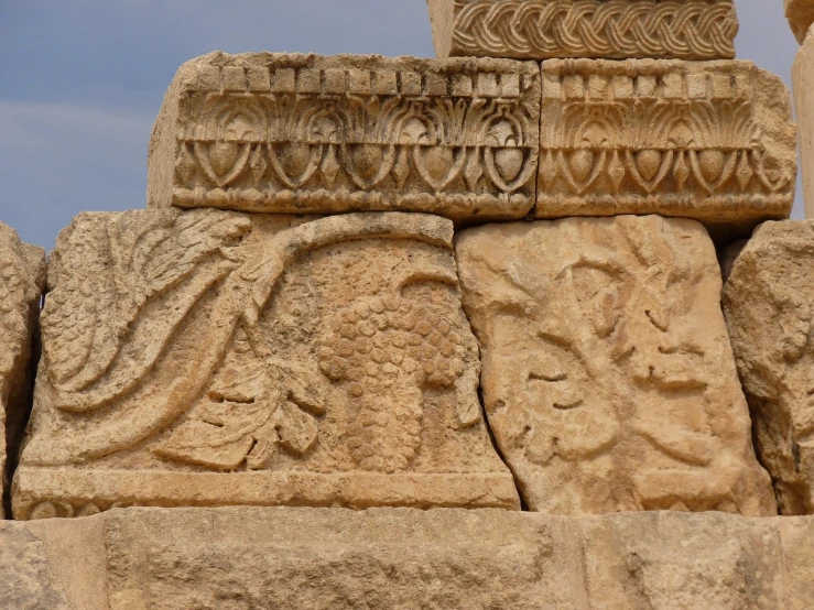 a close up of a stone structure with carvings on it, by Steven Belledin, romanesque, harvest, ancient ruins under the desert, decorated with opera motifs, closeup photo