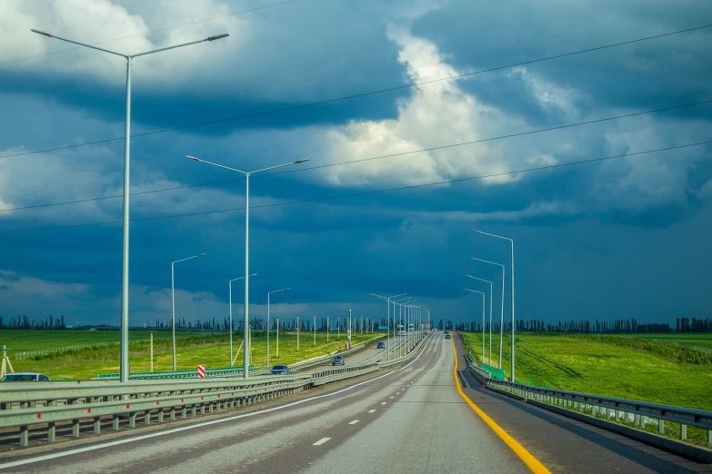 a view of a highway on a cloudy day, by Hristofor Zhefarovich, shutterstock, realism, russian landscape, modern high sharpness photo, springtime, guardrails