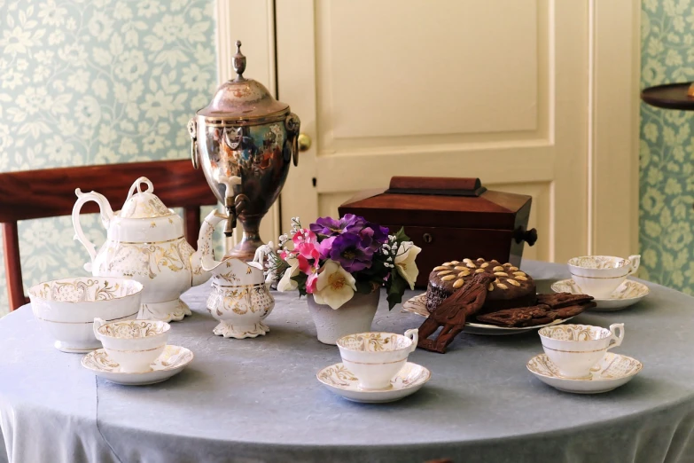 a table that has some cups and saucers on it, art nouveau, historical setting, set in 1 8 6 0, set photo