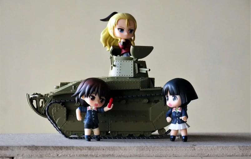 a couple of action figures sitting on top of a tank, inspired by Kawabata Ryūshi, flickr, k-on!, petite girl, class tank, overlord!!!