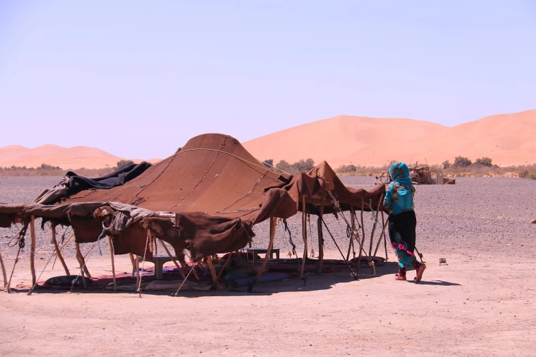 a woman standing in front of a tent in the desert, flickr, les nabis, canopies, children, panorama, tastes