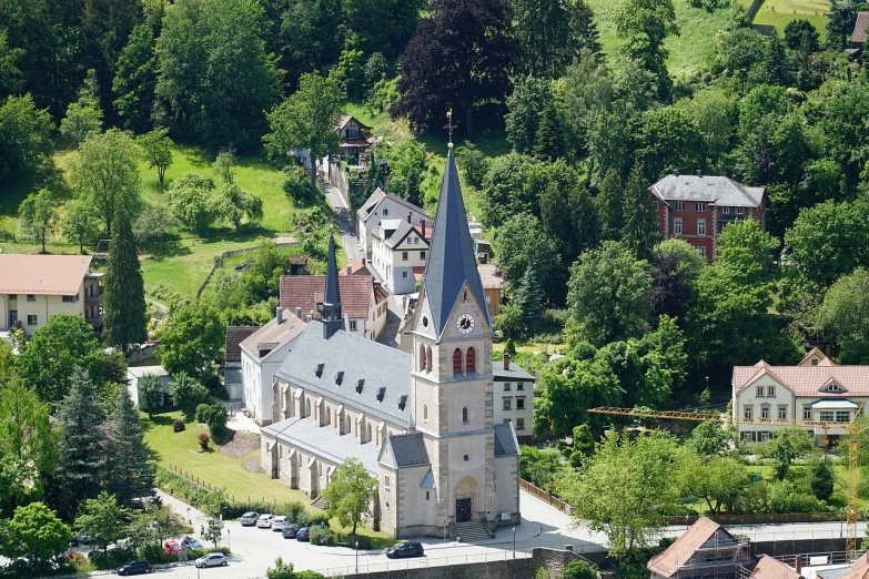 a church sitting on top of a lush green hillside, by Johannes Martini, flickr, romanesque, viewed from bird's-eye, berkerk, beautiful small town, broad detail