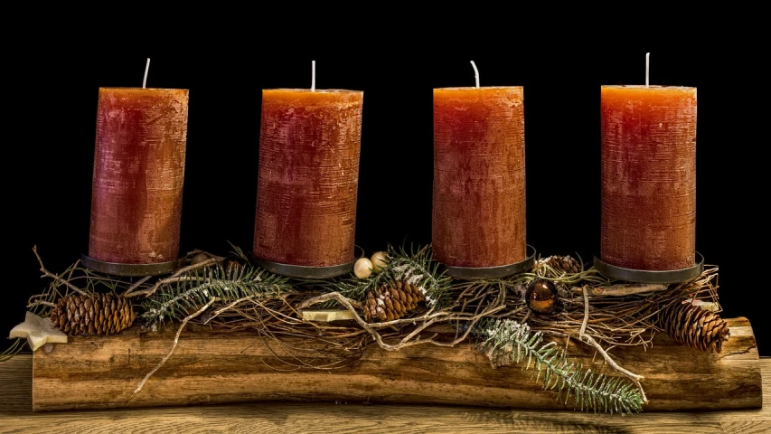 a group of three candles sitting on top of a wooden table, by Carol Bove, pixabay, folk art, red and brown color scheme, wooden logs, 🦩🪐🐞👩🏻🦳, centerpiece