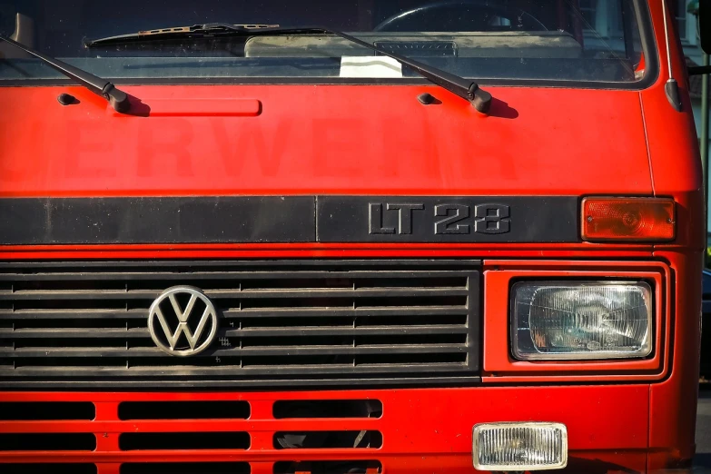 a close up of the front of a red truck, by Matthias Weischer, 1128x191 resolution, fire theme, microbus, banner