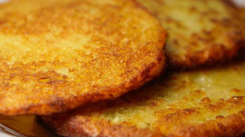 a close up of some food on a plate, by Grytė Pintukaitė, pixabay, renaissance, potato skin, pancakes, 3/4 view from below, shady