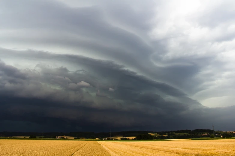 a storm moves across the sky over a wheat field, a picture, by Thomas Häfner, mothership in the sky, panspermia, tearing, france