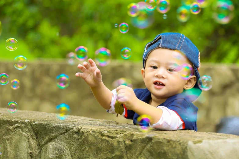 a little boy is playing with soap bubbles, a picture, by Arthur Pan, shutterstock, young cute wan asian face, ja mong, screengrab, happiness!