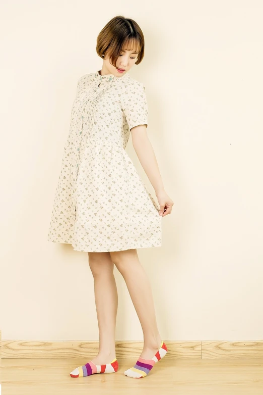 a woman standing on top of a hard wood floor, a portrait, by Yokoyama Taikan, rococo, summer dress, productphoto, elegant slim beige shirt, cute dress