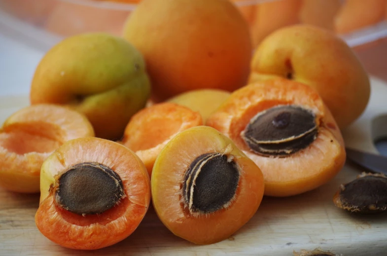 a bunch of fruit sitting on top of a cutting board, a portrait, by Peter de Sève, trending on pixabay, renaissance, brown almond-shaped eyes, in shades of peach, japan harvest, seen from below