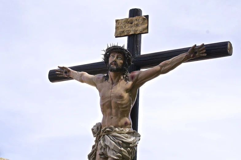 a statue of jesus on a cross with a sky background, by Thomas Bock, figuration libre, madrid, istockphoto, disrobed, shot on a 2 0 0 3 camera