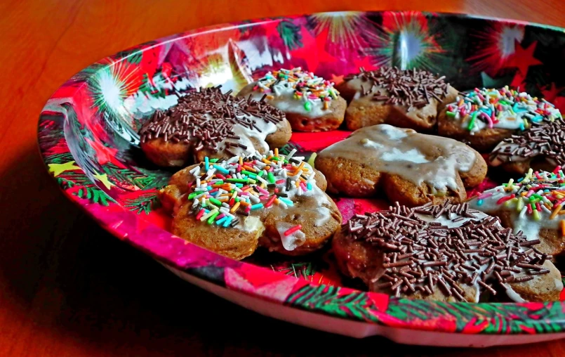 a plate of doughnuts with frosting and sprinkles, flickr, renaissance, gingerbread candy village, “ iron bark, sfw version, recipe