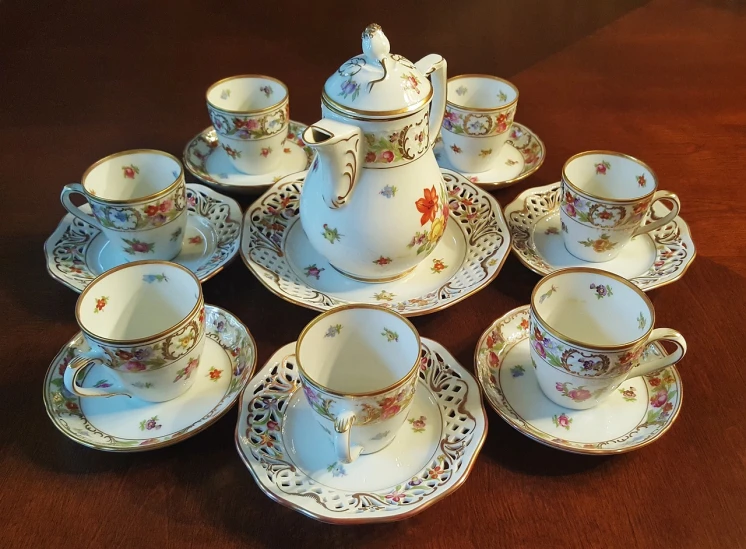 a table topped with cups and saucers on top of a wooden table, by Johann Christian Brand, flickr, rococo, listing image, hexagonal shaped, toddler, chocolate