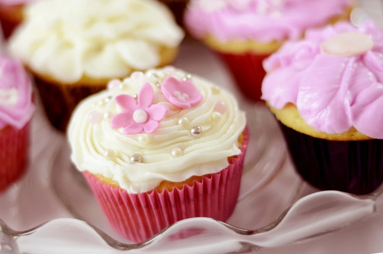 a plate of cupcakes with pink frosting and sprinkles, a picture, romanticism, pearls, 3 4 5 3 1, cream, detailed flowers