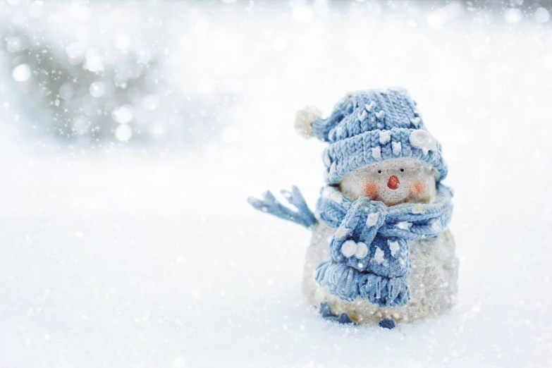 a snowman wearing a hat and scarf in the snow, a picture, by Emma Andijewska, shutterstock, blue! and white colors, cozy wallpaper, closeup photo, stock photo