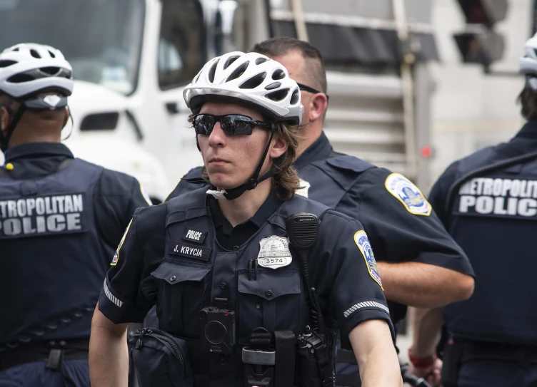 a group of police officers standing next to each other, by Kathleen Scott, reddit, photorealism, goggles on forehead, washington dc, picture of a male biker, usa-sep 20