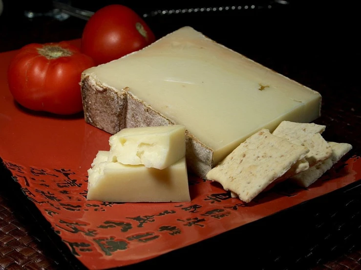 a red plate topped with cheese and tomatoes, a picture, flickr, mingei, ivory, auslese, split in half, bovine