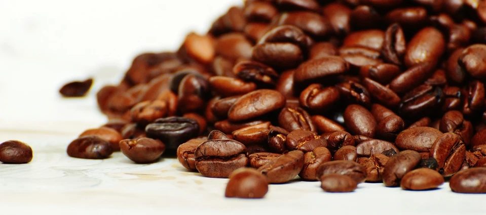 a pile of coffee beans sitting on top of a table, a photo, flickr, photo photograph, recipe, closeup photograph, drip