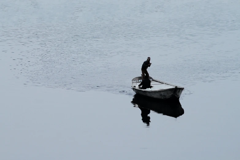 a man in a boat on a body of water, a picture, by János Tornyai, flickr, grey, working, silhuette, top down photo