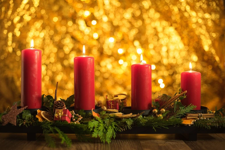 a group of red candles sitting on top of a wooden table, shutterstock, relaxed. gold background, christmas night, wonderful details, yellow and red color scheme