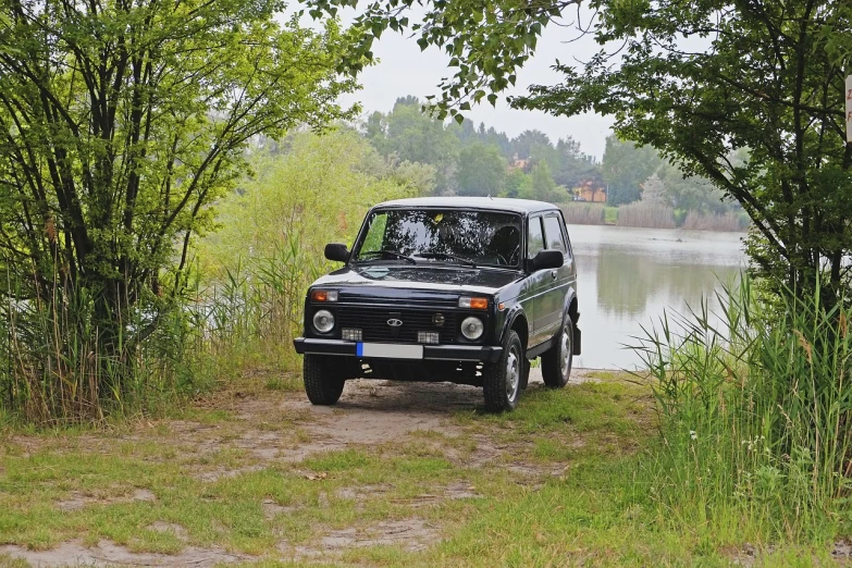 a black suv parked next to a body of water, a picture, by Petr Brandl, flickr, romanticism, lada, portrait!!!!, old school fpr, fishing