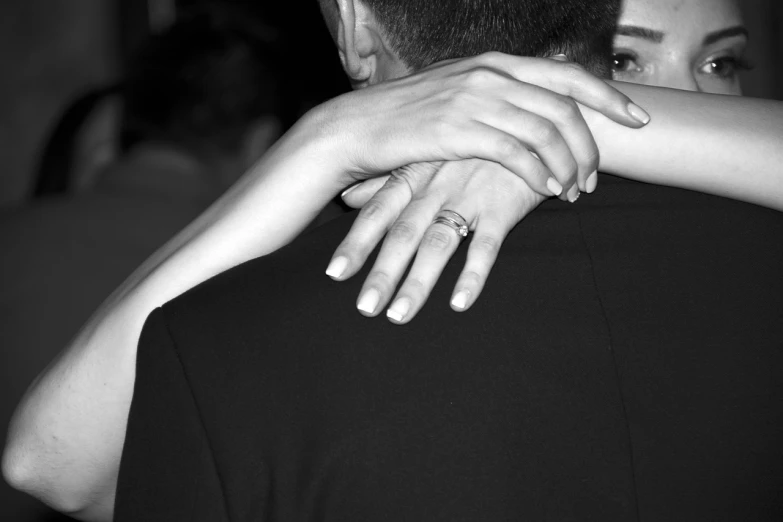 a black and white photo of a man hugging a woman, pexels, ring flash closeup photograph, with his back turned, elegant pose, sleek hands