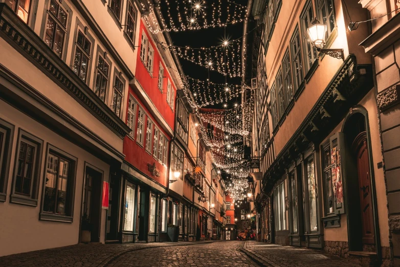 a street filled with lots of lights next to tall buildings, pexels, hyperrealism, detmold, fancy medieval architecture, 🕹️ 😎 🔫 🤖 🚬, string lights