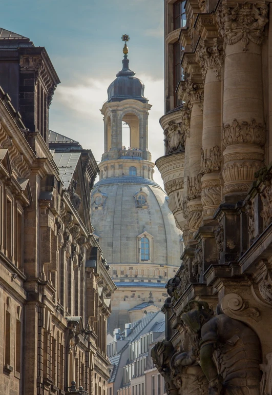 a clock that is on the side of a building, a photo, inspired by Christopher Wren, baroque, neoclassical tower with dome, elegant walkways between towers, qwek dom, view from behind