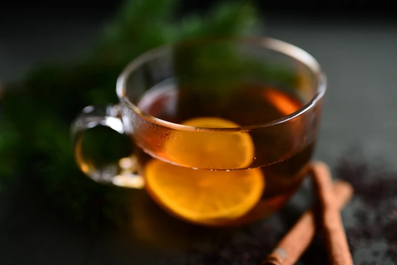 a cup of tea with orange slices and cinnamon sticks, a portrait, by Adam Marczyński, pexels, renaissance, glass with rum, square, half moon, festive