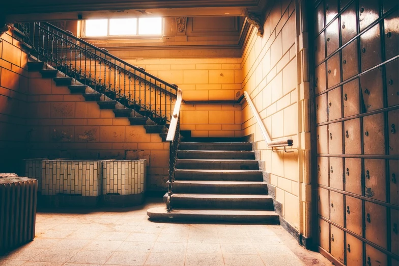 a hallway with a bunch of lockers and a set of stairs, a picture, shutterstock, bauhaus, bathed in golden light, old stone steps, vintage saturation, an empty office hallway