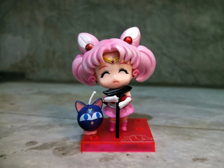 a close up of a figurine of a girl with a cat, a picture, by Sailor Moon, purism, 😃😀😄☺🙃😉😗, pink angry bubble, shooting pose, chibi