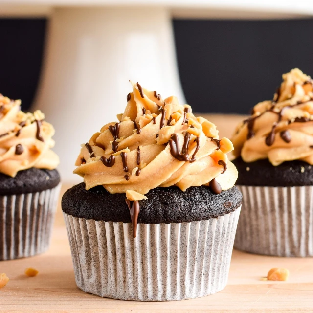 a couple of cupcakes sitting on top of a wooden table, by Bernardino Mei, shutterstock, gold and black color scheme, with dark brown bangs, close-up product photo, stacked image