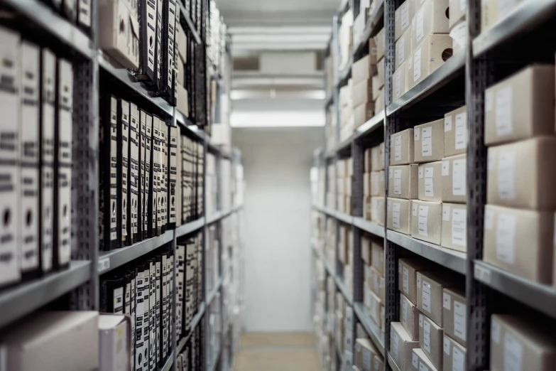 a room filled with lots of boxes and shelves, by Konrad Witz, pexels, open bank vault, shot of film, grey warehouse background, confidential documents