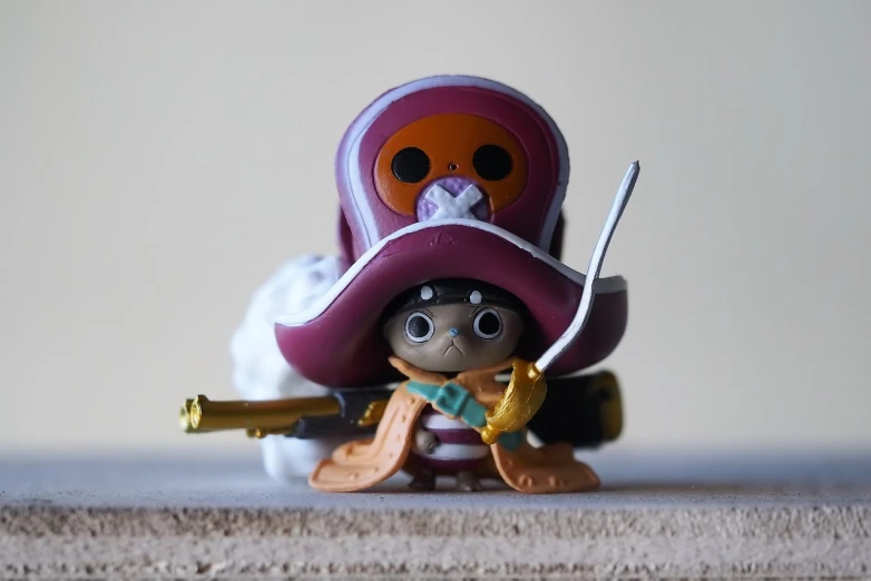 a close up of a toy on a table, a picture, inspired by Eiichiro Oda, unsplash, funko pop”, pirate queen, two characters, archwizzard in a hat