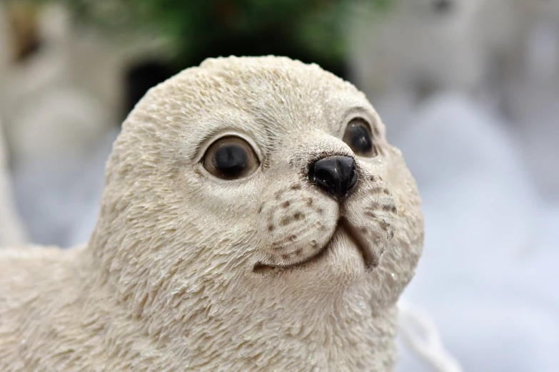 a close up of a figurine of a seal, a portrait, by Jeanna bauck, highly detailed photo of happy, -w 1024, ornament, high detailed)