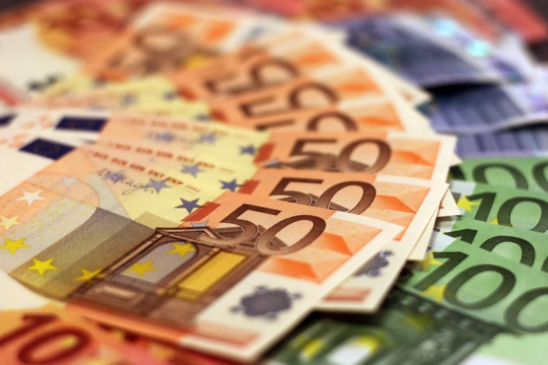 a pile of money sitting on top of a table, a digital rendering, by Matija Jama, pixabay, figuration libre, zoomed view of a banknote, european union, nice colors, wallpaper!