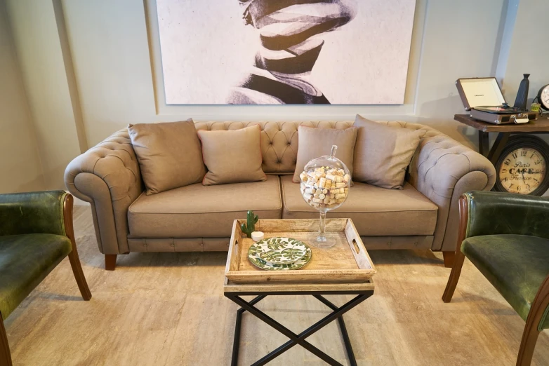 a living room filled with furniture and a clock, inspired by Emilio Grau Sala, pexels, tanned ameera al taweel, beige, sofa, chesterfield