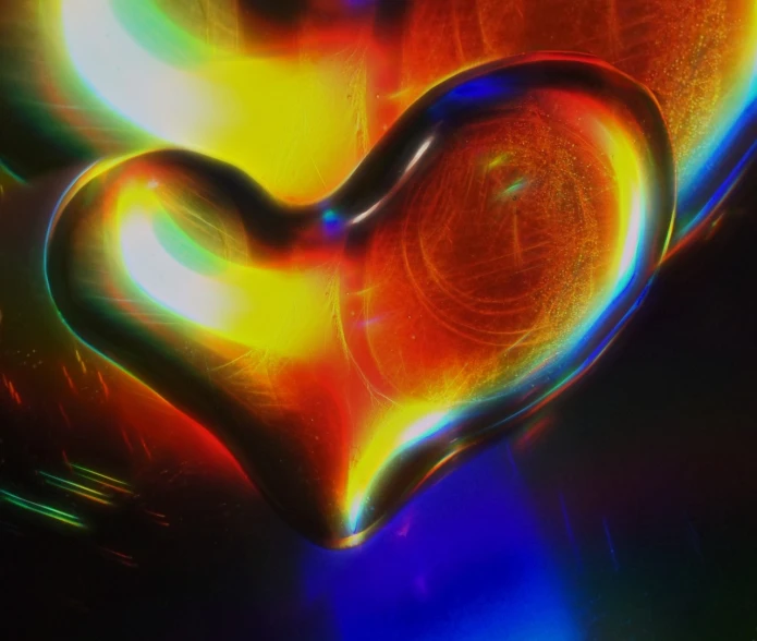 a heart shaped object sitting on top of a table, by Jan Rustem, digital art, gold black and rainbow colors, closeup - view, flares anamorphic, iphone background