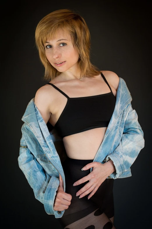 a woman in tights and a denim jacket, a portrait, inspired by Elizabeth Polunin, wearing a cropped black tank top, glamour photography, promotional photoshoot, tia masic