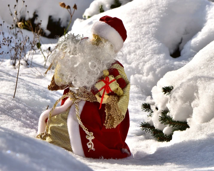 a santa claus figurine sitting in the snow, a photo, pixabay, fine art, ornately dressed, giving gifts to people, high res photo, viewed in profile from far away